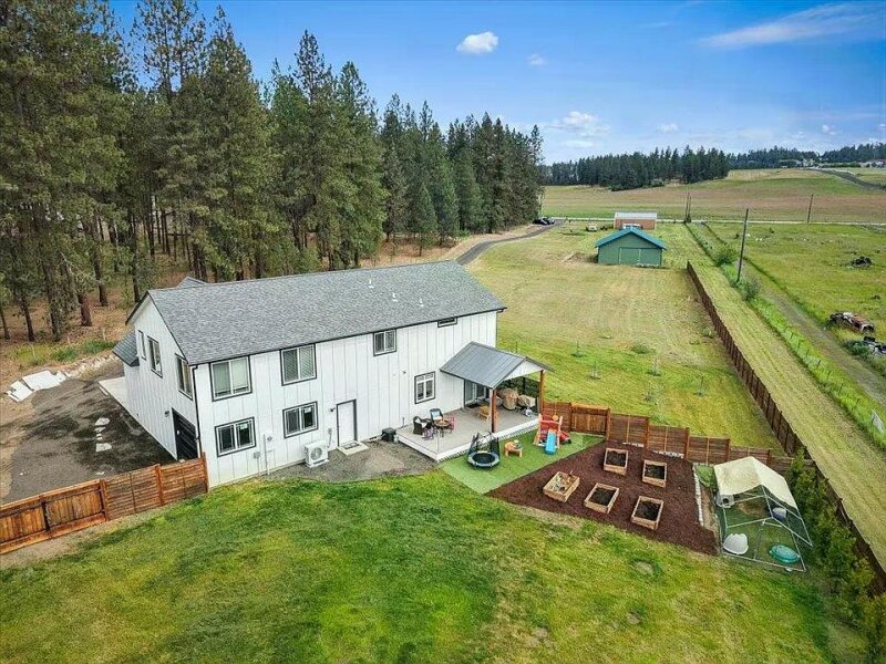 CUSTOM GREEN BLUFF HOME WITH ACREAGE, PASTURE, & TWO 