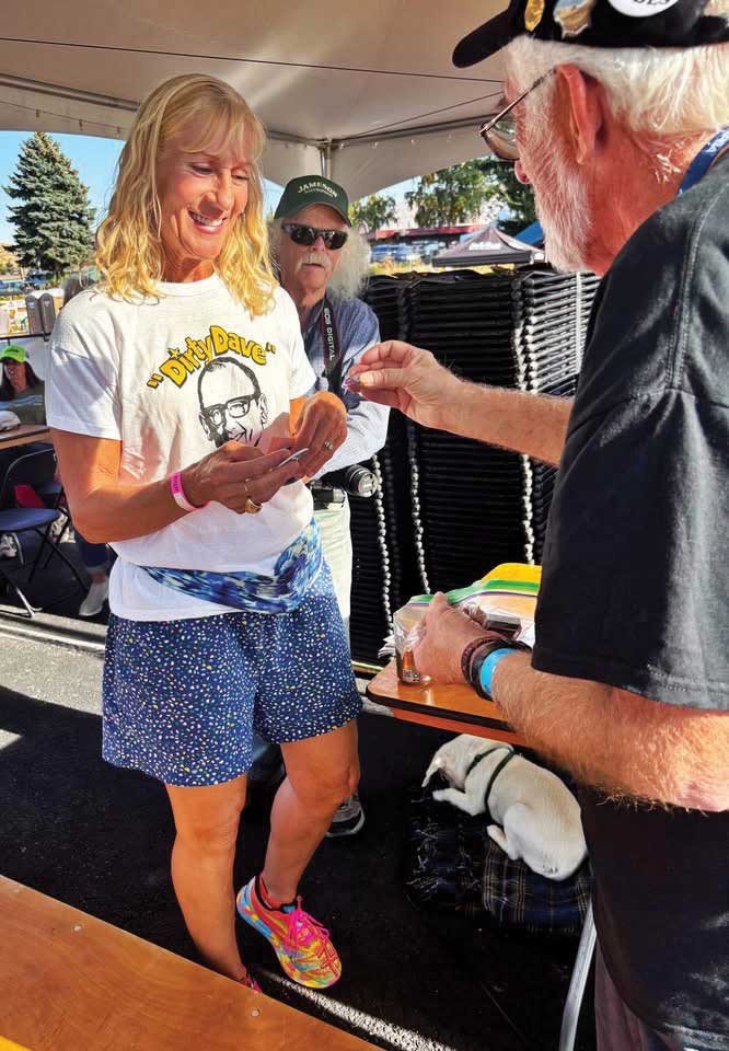 Julie presented the check as Mark Evans, Herman Marchetti, and Stephen Shepperd watched the ceremony. 
