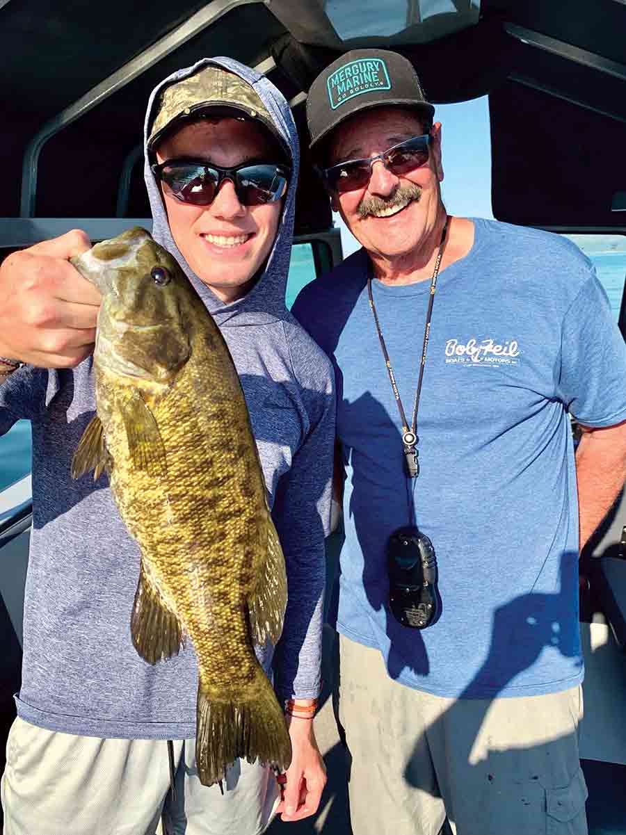 Luke Hawkins and The Fishing Magician posing with a large smallmouth bass caught on a topwater lure at Banks Lake.