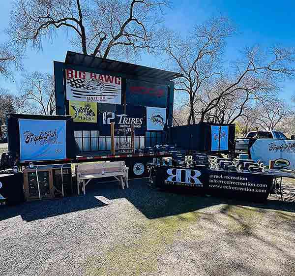 A stage loaded with prizes and trophies for participants of the Banks Lake Triple Fish Challenge, hosted by Reel Recreation.