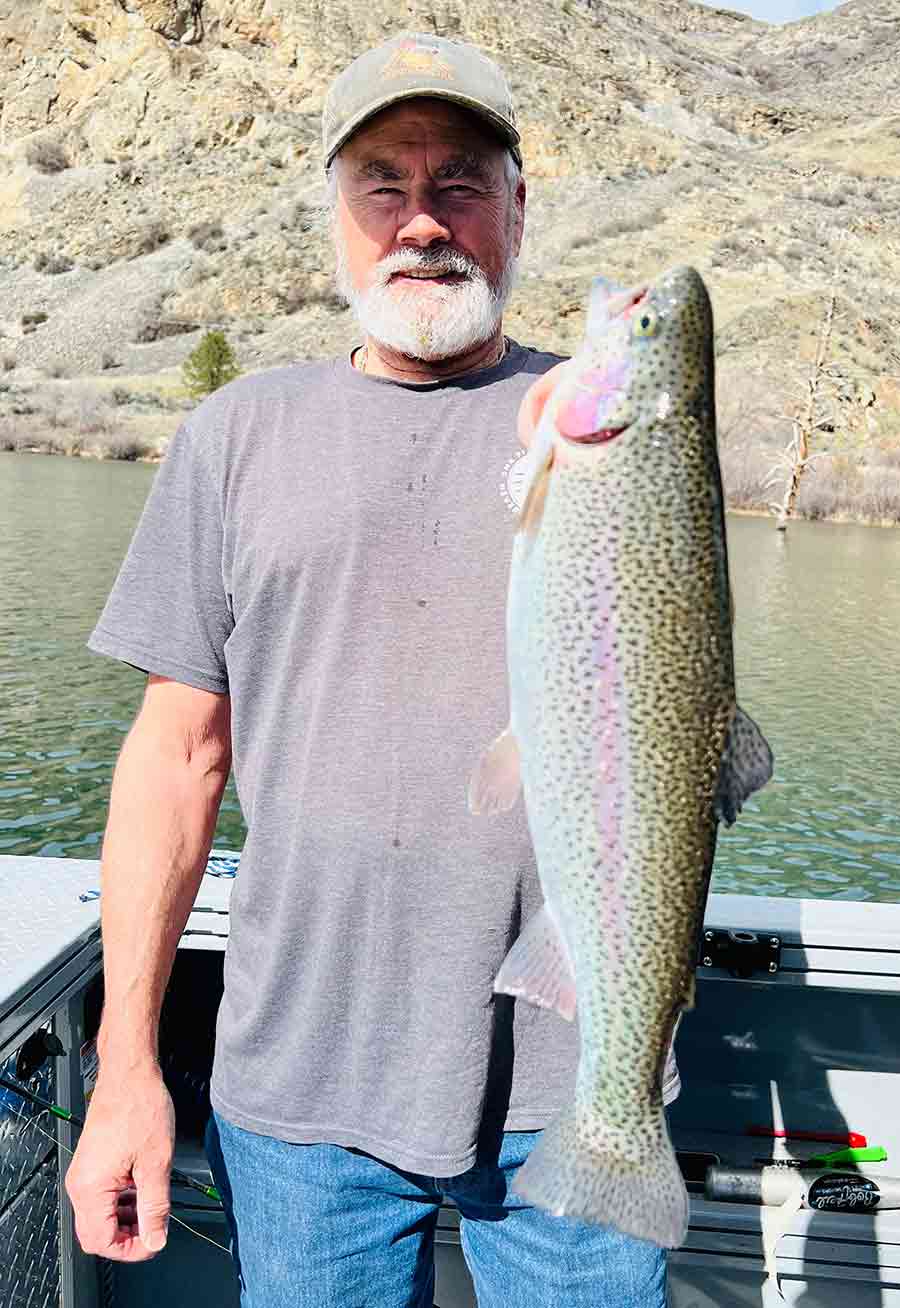 Dennis Beich fishing at Rufus Woods Reservoir on a sunny spring day.