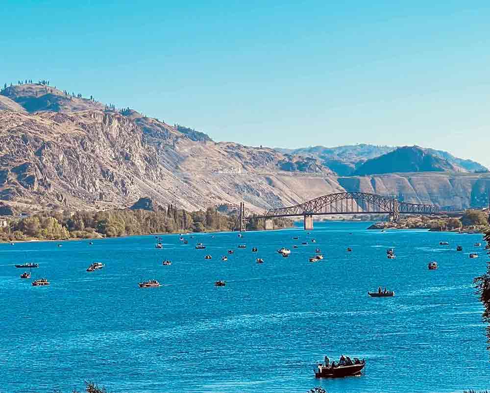 Opening day of salmon season at Chelan Falls, featuring anglers preparing along the shoreline.